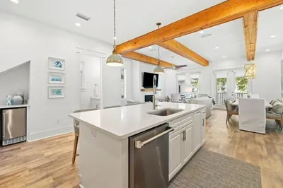 an open kitchen with a sink and a living room at Villa Bianca in Seacrest