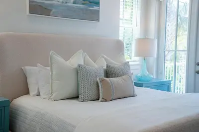 a bedroom with a white bed with pillows at Villa Bianca in Seacrest