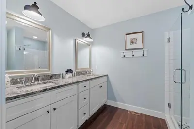 a white bathroom with two sinks and a shower at Seahorse Landing in Seagrove Beach