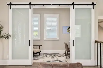 a living room with white doors and a couch at Casa de Sol in Inlet Beach