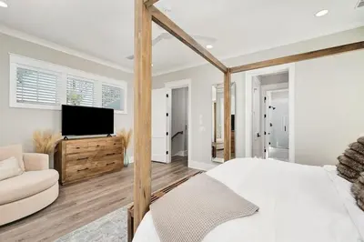 a bedroom with a bed and a tv and a couch at Casa de Sol in Inlet Beach