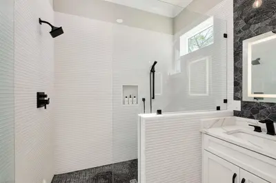a white bathroom with a shower and a sink at Casa de Sol in Inlet Beach