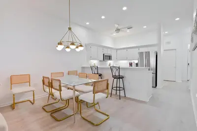 a dining room and kitchen with a table and chairs at Gulfs Edge Townhome #7- Sun-Kissed Memories by Emerald Coast Retreats in Panama City Beach