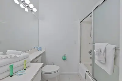 a white bathroom with a toilet and a shower at Gulfs Edge Townhome #7- Sun-Kissed Memories by Emerald Coast Retreats in Panama City Beach