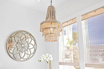 a chandelier hanging in a room with windows at Sweet Southern Charm in Seacrest