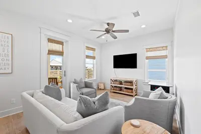 a living room with two couches and a flat screen tv at Sweet Southern Charm in Seacrest