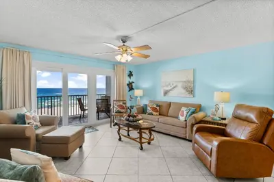 a living room with a couch and a ceiling fan at Mariner West #403 in Panama City Beach