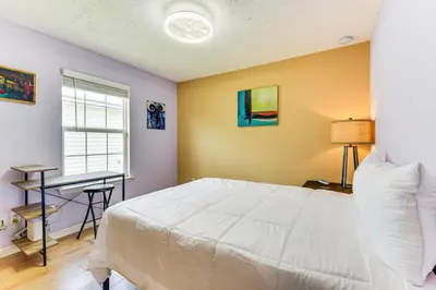 a bedroom with a white bed and a desk at 2 Mi to Beach and Boating Family Home in Lynn Haven in Lynn Haven