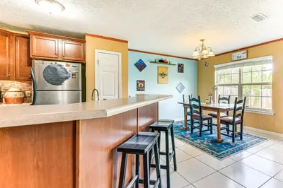 a kitchen with a counter and a table and chairs at 2 Mi to Beach and Boating Family Home in Lynn Haven in Lynn Haven