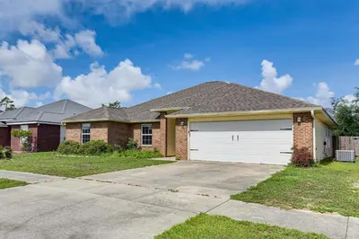 a brick house with a white garage at 2 Mi to Beach and Boating Family Home in Lynn Haven in Lynn Haven