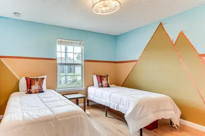 two beds in a room with colorful walls at 2 Mi to Beach and Boating Family Home in Lynn Haven in Lynn Haven
