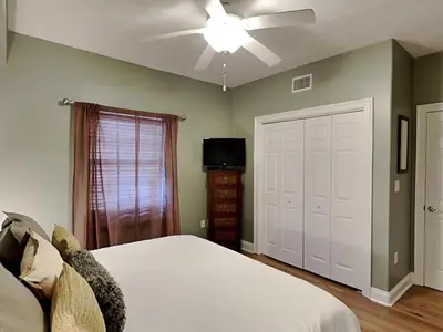 a bedroom with a white bed and a ceiling fan at Treasure Island #1707 in Panama City Beach