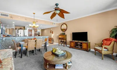 a living room with a couch and a tv at Palazzo 1405 by Emerald Coast Retreats in Panama City Beach