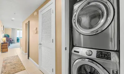 a washing machine and a washer and dryer in a room at Palazzo 1405 by Emerald Coast Retreats in Panama City Beach