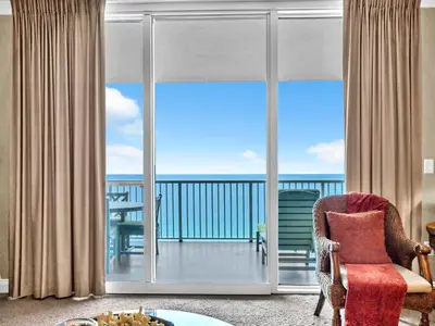 a room with a balcony with a view of the ocean at Palazzo 1405 by Emerald Coast Retreats in Panama City Beach
