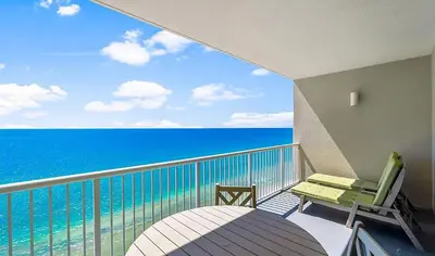 a balcony with a chair and a view of the ocean at Palazzo 1405 by Emerald Coast Retreats in Panama City Beach