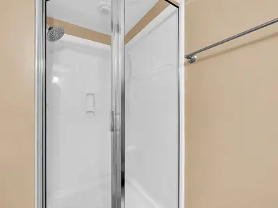 a glass shower door in a bathroom at Palazzo 1405 by Emerald Coast Retreats in Panama City Beach