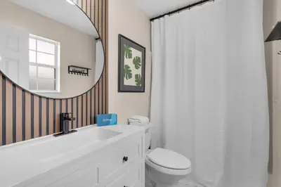 a bathroom with a sink and a toilet and a mirror at Pier Atlas (3/2) in Panama City Beach
