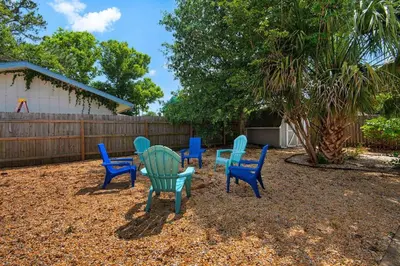 a group of chairs and a table in a yard at Pier Atlas (3/2) in Panama City Beach