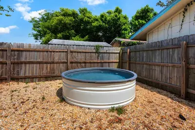 a hot tub in a yard next to a fence at Pier Atlas (3/2) in Panama City Beach