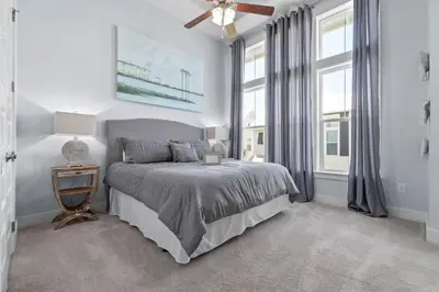 a bedroom with a bed and two windows at Sunny Side Up in Inlet Beach