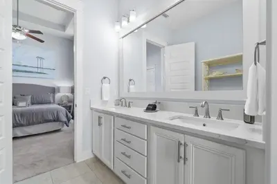 a white bathroom with a sink and a bed at Sunny Side Up in Inlet Beach