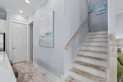 a staircase in a home with white walls at Sunny Side Up in Inlet Beach