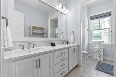 a white bathroom with a sink and a mirror at Sunny Side Up in Inlet Beach