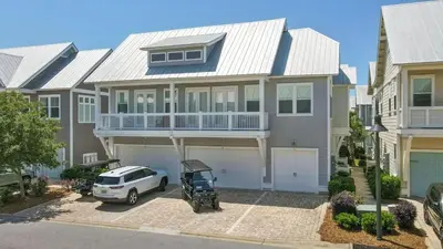 a house with a car parked in front of it at Sunny Side Up in Inlet Beach