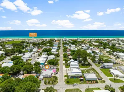 an aerial view of a parking lot next to the beach at Pink Prerogative Beach Bungalow with Private Pool in Panama City Beach