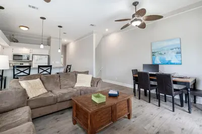 a living room with a couch and a table at Tranquil Beach & Hot Tub & Pool Getaway in Panama City Beach
