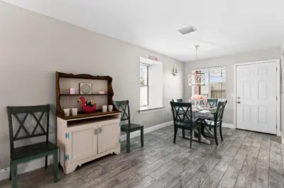 a dining room with a table and chairs at The Pink Flamingo by Book That Condo in Panama City Beach