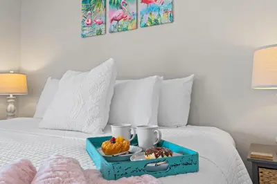 a blue tray with food on a bed at The Pink Flamingo by Book That Condo in Panama City Beach