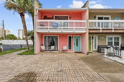 a pink house with a balcony and a patio at The Pink Flamingo by Book That Condo in Panama City Beach