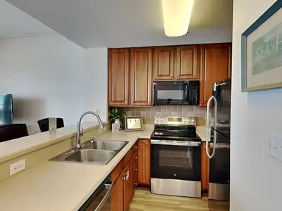 a kitchen with a sink and a stove top oven at Seychelles #206 in Panama City Beach