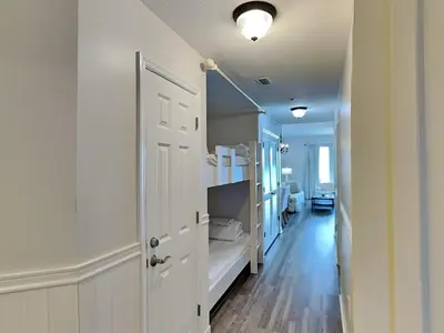a room with a hallway with a white door and a room with a hallway at Seychelles #206 in Panama City Beach