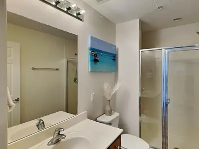 a bathroom with a sink and a toilet and a mirror at Seychelles #206 in Panama City Beach
