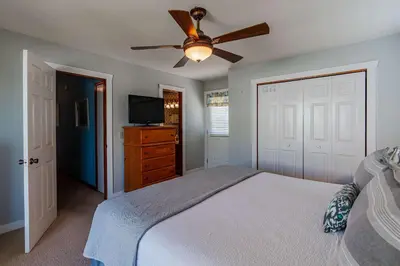 a bedroom with a bed and a ceiling fan at Horizon Breeze - Family Escape in Panama City Beach