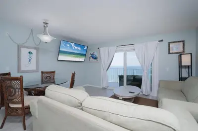 a living room with a white couch and a table at 1BR Sleeps 5 at The Summit with Ocean Front Views in Panama City Beach