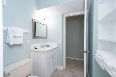 a white bathroom with a sink and a mirror at 1BR Sleeps 5 at The Summit with Ocean Front Views in Panama City Beach