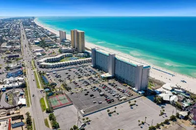 an aerial view of a beach with buildings and cars at 1BR Sleeps 5 at The Summit with Ocean Front Views in Panama City Beach