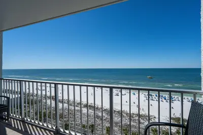 a balcony with a view of the beach and the ocean at Mariners Retreat - High Rise Beach Living in PCB in Panama City Beach