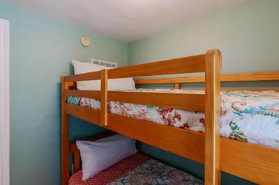 a bedroom with two bunk beds in a room at Ocean View Escape - Beach Resort in Panama City Beach