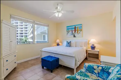 a bedroom with a bed and a couch at Ocean View Escape - Beach Resort in Panama City Beach