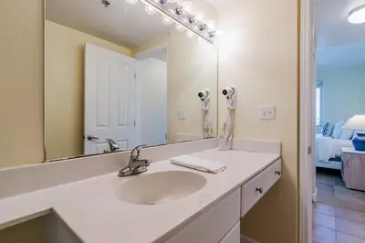 a bathroom with a sink and a mirror at Ocean View Escape - Beach Resort in Panama City Beach