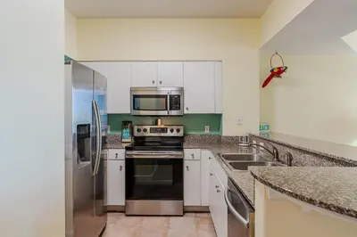 a kitchen with a stove and a microwave at Ocean View Escape - Beach Resort in Panama City Beach