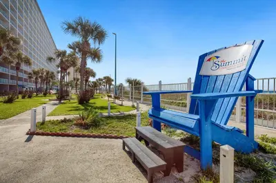 a giant blue chair sitting next to a park at Ocean View Retreat - Beachfront Bliss in Panama City Beach