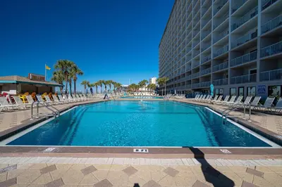 a large swimming pool in front of a building at Ocean View Retreat - Beachfront Bliss in Panama City Beach