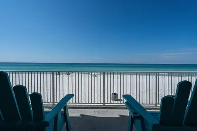 a view of a beach with chairs and the ocean at Coral Cove Beachfront Condo for 3 with Onsite Pool in Panama City Beach