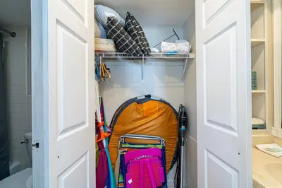 a closet with a tent and skis in it at Coral Cove Beachfront Condo for 3 with Onsite Pool in Panama City Beach
